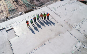 Construction workers at construction site discussing city development strategy
