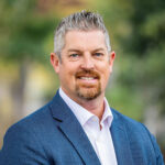 Headshot of Matthew Tate who brings 15 years of experience at the intersection of the public and private sectors to his role at Capital Rivers Connect.